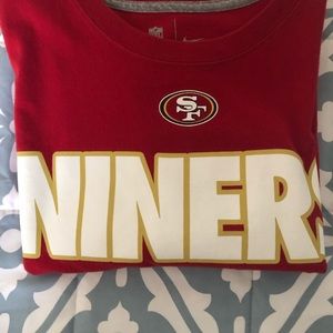 San Francisco 49ers shirt.